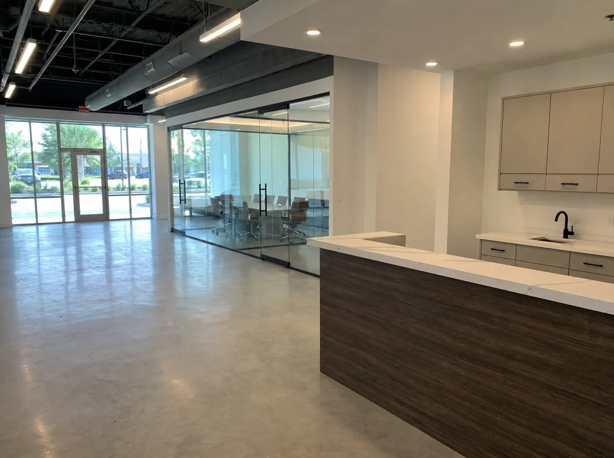 Finished commercial tenant build-out with polished concrete floors, an open ceiling and a reception counter