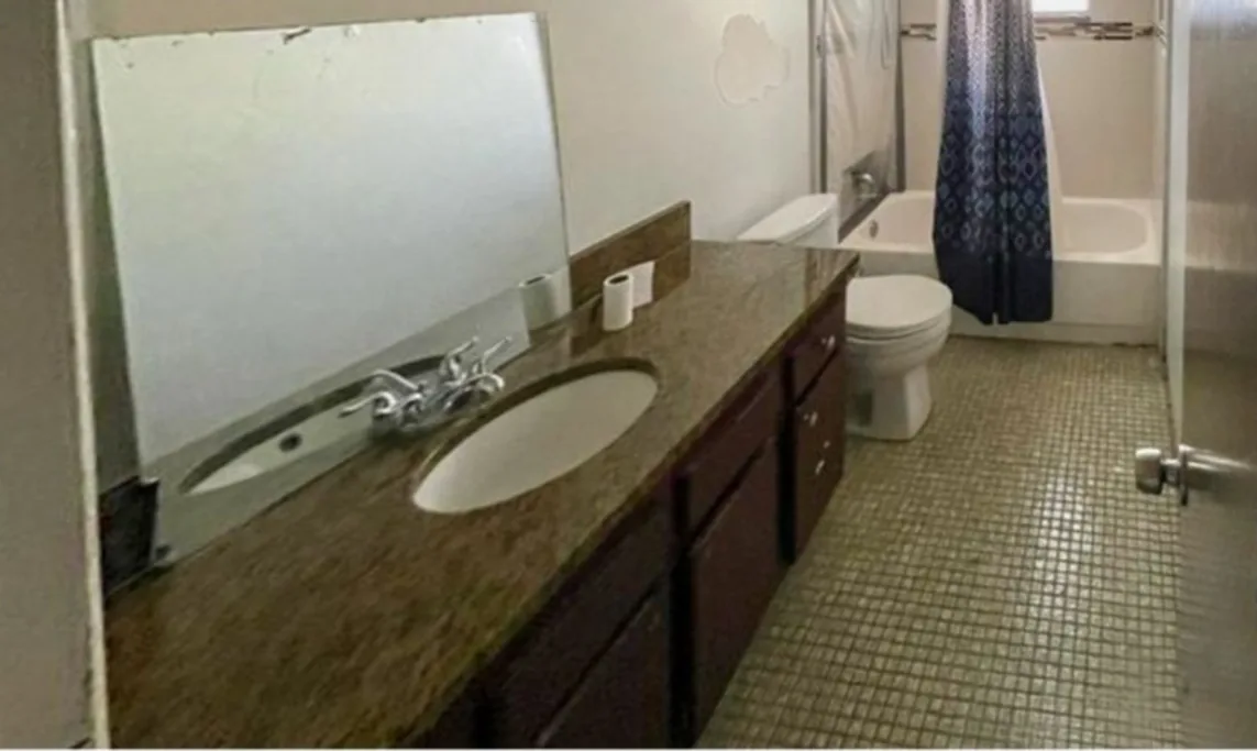 Before: Bathroom before the remodel: dated vanity and shower