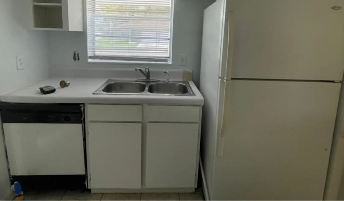 Before: Kitchen before the remodel: dated white cabinets