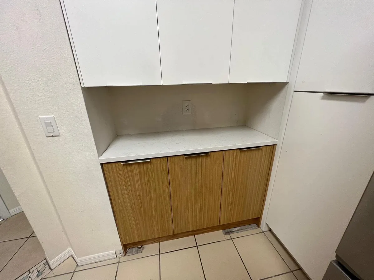 Built in hutch with white slab uppers and wood grain base under quartz