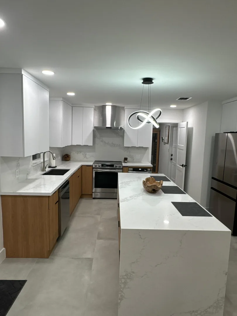 White and walnut kitchen with a white veined quartz waterfall island
