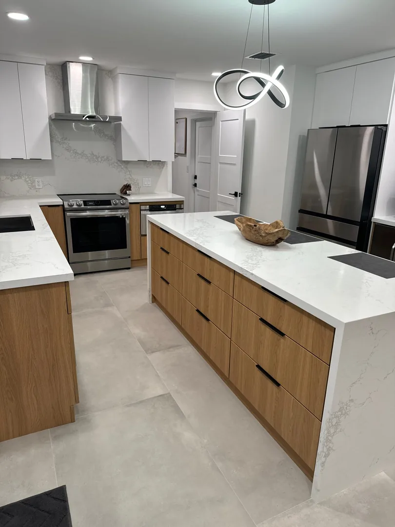 Walnut island with a white quartz waterfall top and sculptural pendant